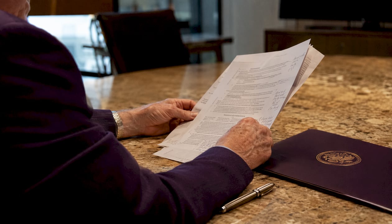 Hands holding federal solicitation documents