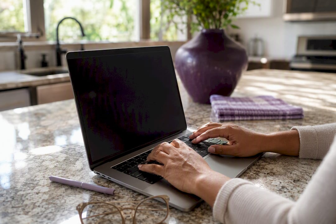 Hands taking screenshot on laptop keyboard
