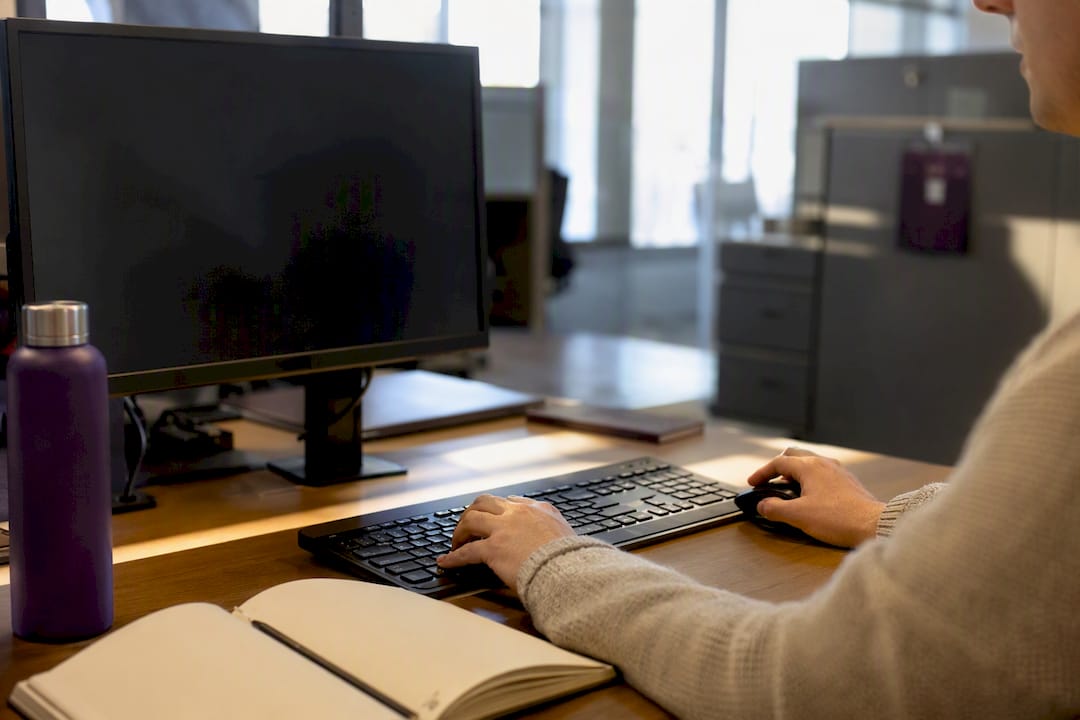Hands using computer analyzing procurement forecasts