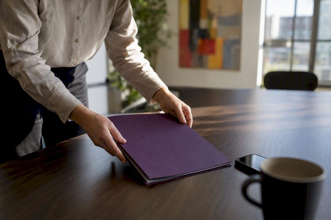 Hands arranging capability statement folder