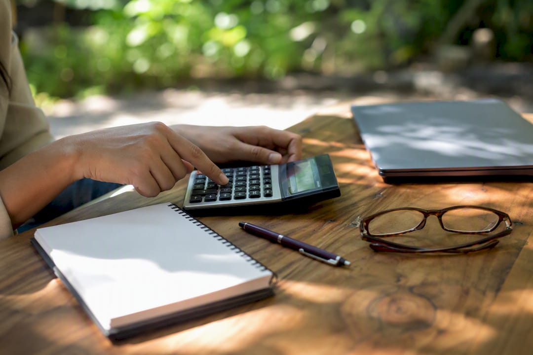 Hands calculating with calculator on desk