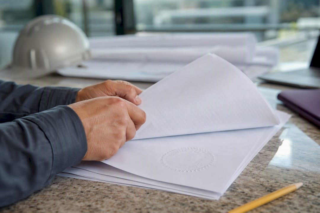 Hands handling bonding capacity documents