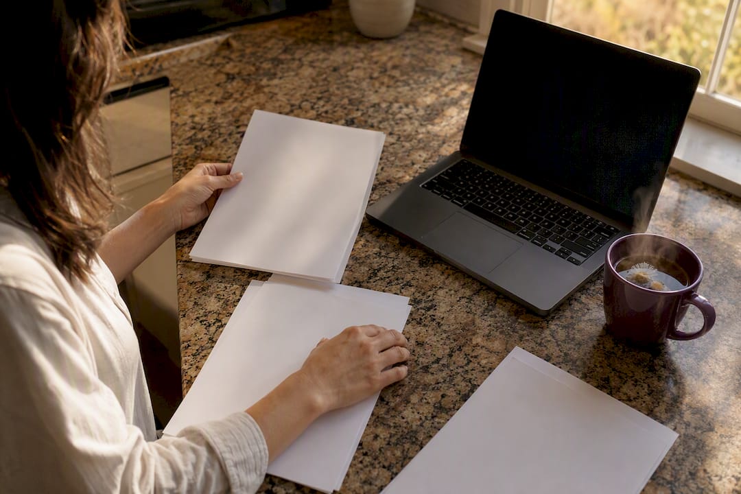 Hands arranging workspace for capability statement