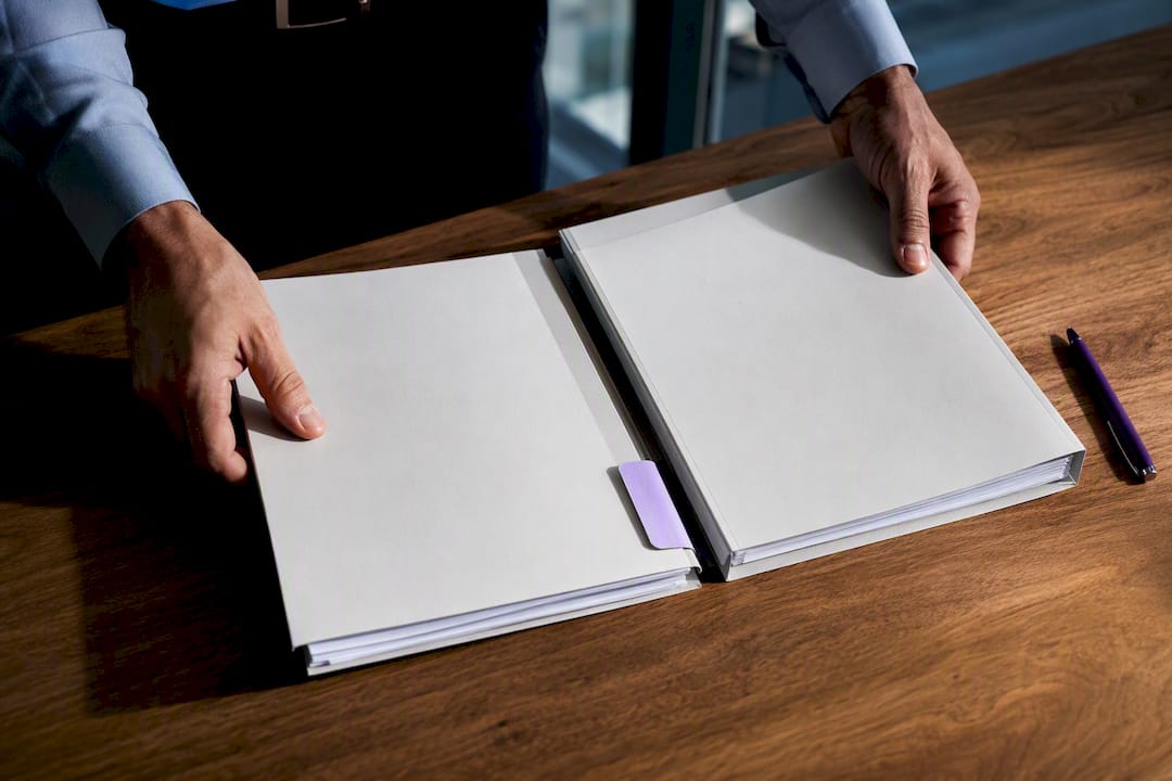 Hands aligning registration and submission records
